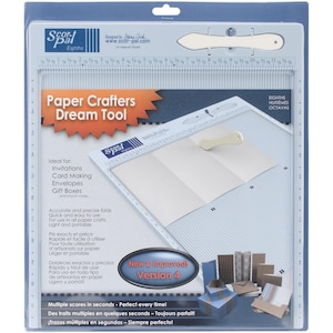 May include: A paper crafting tool with the text "Paper Crafters Dream Tool". The tool is white and gray, with a scoring board and a bone folder. It is designed for making invitations, cards, envelopes, and gift boxes.
