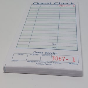 Può includere: Un conto del ristorante bianco con una griglia verde e il testo "Guest Check" e "Guest Receipt". Il numero del conto è 3067-1. Il numero del tavolo è SA540A.