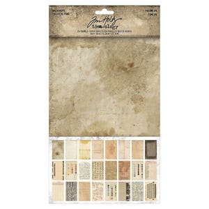 May include: A pack of 24 double-sided paper sheets for crafting. The pack is labeled "Jim Holtz idea-ology" and "Volume #4 Tome #4". The sheets feature a variety of vintage-inspired designs, including text, numbers, and patterns.