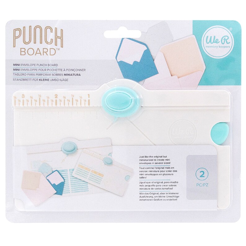 May include: White plastic punch board with a blue handle and ruler for creating mini envelopes. The packaging includes the text "Punch Board" and "We R Memory Keepers".
