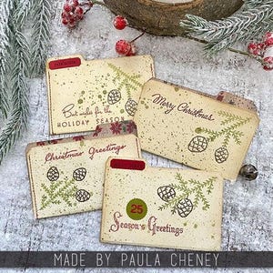 May include: Four vintage-style file folder cards with holiday greetings. Each card features a pine cone and branch design, with text that reads "Best wishes for the HOLIDAY SEASON", "Merry Christmas", "Christmas Greetings", and "Season's Greetings".