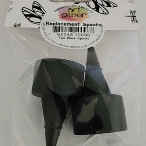 May include: Two black replacement spouts for art glitter bottles. The package includes the text "Replacement Spouts" and "Two Black Spouts" along with the barcode 62048 10096.