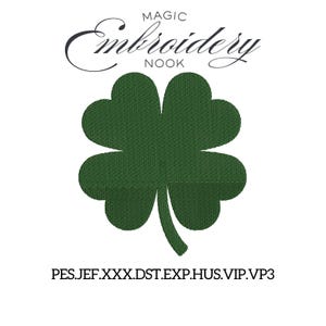 May include: A dark green four-leaf clover design, with the text "MAGIC Embroidery NOOK" in a script font above. Below the clover, the text "PES.JEF.XXX.DST.EXP.HUS.VIP.VP3" is displayed. The clover is centered on a white background.
