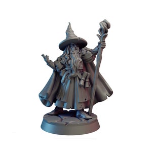 May include: A gray painted miniature figurine of a wizard with a long white beard, wearing a pointed hat and a long robe, holding a staff. The wizard is standing on a round base.