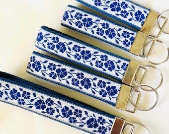 BLUE BELL Key Fob. Jacquard fob Royal blue on white. Blue webbing. Silver nickel hardware. Wristlet. 1" wide, Size choice. Wedding favors