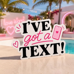 May include: A white die-cut sign featuring the black text I'VE and TEXT! with the pink script text got a in the center. The design includes a pink smartphone icon with a heart on the screen and two small pink heart outlines on the left side.