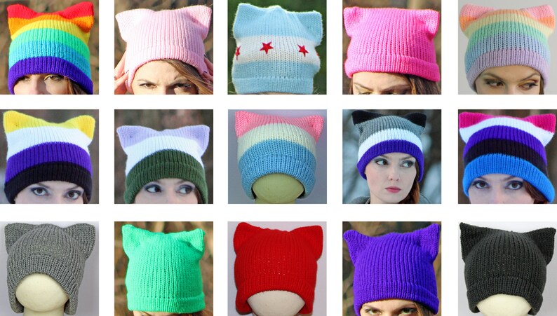 May include: A collection of 15 colorful knit hats with cat ears. The hats are in various colors, including rainbow, pink, blue, green, red, purple, and gray. Some of the hats have stripes or other patterns.