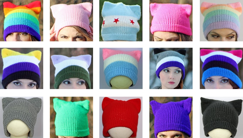 May include: A collection of 15 colorful knit hats with cat ears. The hats are in various colors, including rainbow, pink, blue, green, red, purple, and gray. Some hats feature stripes or other patterns.