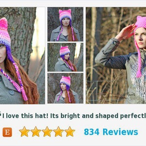 May include: A pink and purple crocheted cat ear hat with long, braided ties. The hat is worn by a person with long, red hair. The hat is shown in multiple angles.