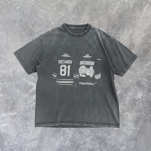 May include: Dark gray t-shirt featuring a graphic of two hockey jerseys. The jersey on the left has the name "ROZANOV" and the number "81". The jersey on the right has the name "HOLLANDER" and the number "24".