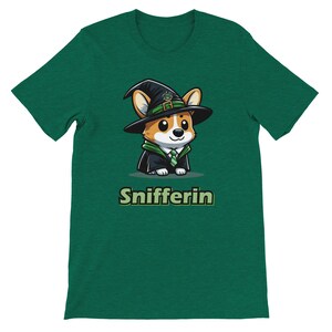 May include: Green t-shirt with a cartoon image of a corgi wearing a witch hat and robe. The text "Snifferin" is printed below the image.
