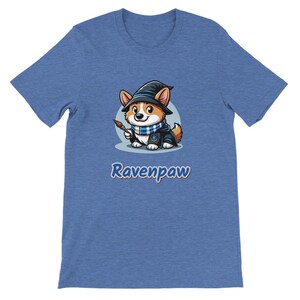 May include: A blue t-shirt with a cartoon image of a corgi wearing a wizard hat and holding a paintbrush. The text "Ravenpaw" is printed below the image.