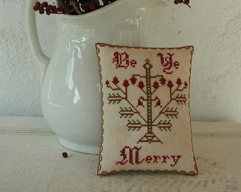 May include: A white pillow with red and brown embroidery depicting a stylized tree with the text "Be Ye Merry".