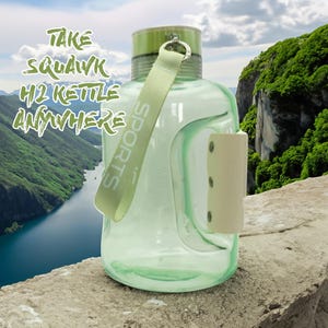 May include: A clear green sports water bottle with a white handle and a green strap that says "SPORTS". The bottle is sitting on a rock with a river and mountains in the background. The text "TAKE SQUAWK H2O KETTLE ANYWHERE" is visible in the image.