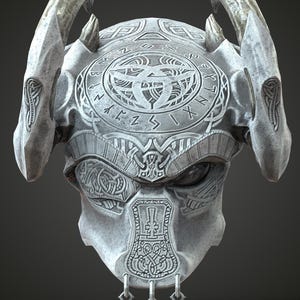 May include: A detailed grey fantasy helmet with intricate carvings and horn-like protrusions. The helmet features a circular design on the crown and decorative patterns across the face and sides. Three small pendants hang from the chin area.