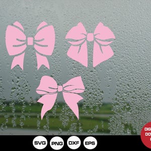 May include: Four pink bow designs on a blurry background of raindrops on a window. The bows are in different sizes and shapes.