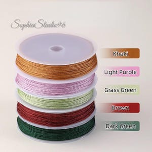 May include: A stack of five circular spools of thin cord in khaki, light purple, grass green, brown, and dark green. The text Sophia Studio96 appears at the top, with color labels Khaki, Light Purple, Grass Green, Brown, and Dark Green listed.