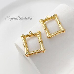May include: Two gold-toned rectangular jewelry charms with a bamboo-inspired texture and a small loop at the top for attachment. The text SophiaStudio96 is visible in the upper left corner of the image, featuring a metallic finish and hollow centers.