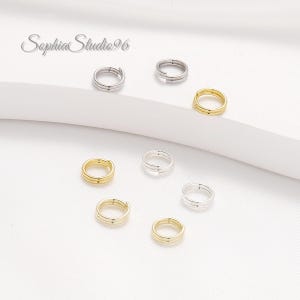 May include: An assortment of small, double-loop jump rings in gold and silver tones. The rings are arranged on a white surface. The brand name "Sophia Studio96" is in the upper left corner.
