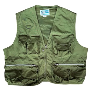 May include: Olive green fishing vest with multiple pockets and a zipper closure. The vest has a D-ring and a small logo on the upper left chest. The vest is made of a lightweight material.