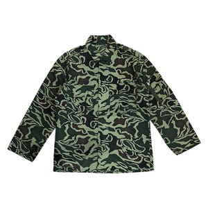 May include: A green camouflage military jacket with a button-up front and long sleeves.