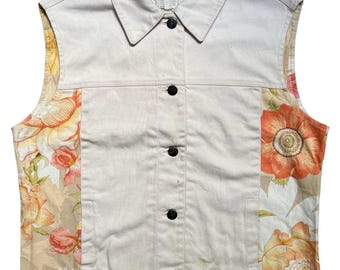 May include: A cream-colored vest with a collared neckline and black button closure. The vest features floral patterned panels in shades of orange, peach, and yellow. The label reads "Salvatore Ferragamo Made in Italy".