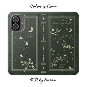 May include: A dark green phone case with a book cover design. The cover features the text "The Magical Tales of Anne Smith" and illustrations of birds, stars, and a crescent moon.