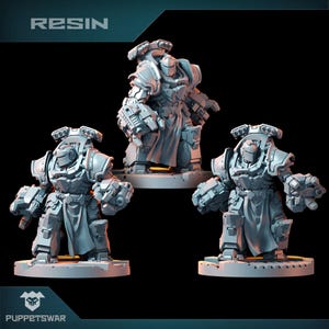 May include: Three resin miniatures of armoured figures, each with detailed mechanical designs and weaponry. The figures are in a standing pose, with a neutral colour palette. The word "RESIN" is at the top of the image, and the logo "PUPPETSWAR" is at the bottom.
