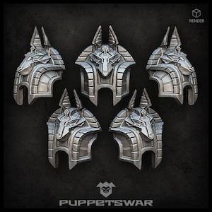 May include: Five silver-colored, detailed, 3D printed Anubis head sculptures. Each sculpture has a distinct design and is a unique piece of art.  The sculptures are arranged in a circular pattern on a dark background.  The text "PUPPETSWAR" is at the bottom of the image.