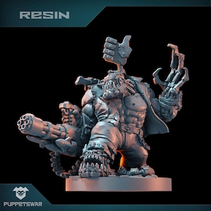 May include: A gray resin miniature of a large, muscular, humanoid figure with a large gun, a mechanical hand, and a thumbs up gesture. The figure is wearing a jacket and pants. The miniature is labeled "RESIN".