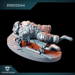 May include: A gray resin miniature of a creature lying on a platform with a lever. The creature has a muscular body and a textured surface. The miniature is labeled "RESIN".