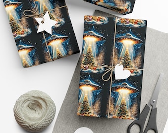 May include: Christmas-themed wrapping paper featuring a repeating pattern of a UFO beaming down on a Christmas tree. The paper is black with a festive design, tied with twine and a star-shaped tag. A spool of twine and scissors are also visible.