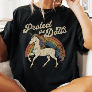 Protect the Dolls Shirt, Trans Rights T-Shirt, LGBTQ Pride Unicorn Tee, Pedro Pascal Inspired Queer Protest Shirt Anti-Trump Democrat Gift Black