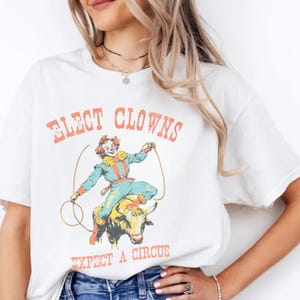 Elect Clowns Expect A Circus T-Shirt Vintage Political Graphic Tee Anti Trump Funny Satirical Government Protest Shirt Retro Clown Rodeo Tee