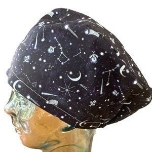 May include: A black scrub hat with a white print of stars, moons, and constellations.