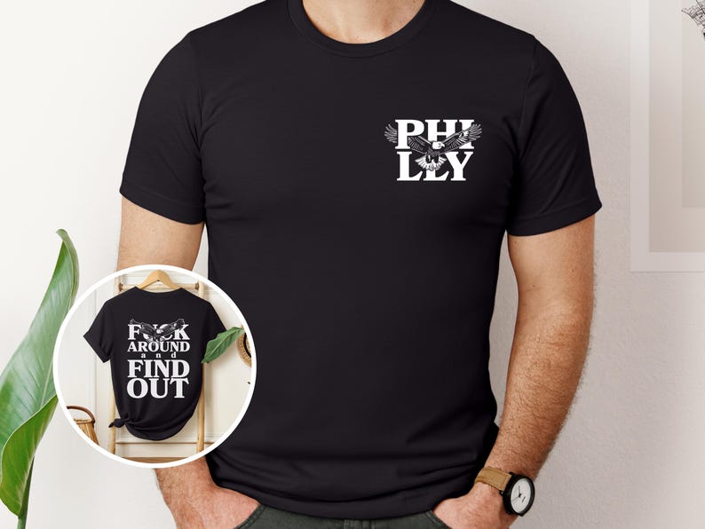 May include: Black t-shirt with a white eagle graphic and the text "PHILLY" on the front. The back of the shirt has the text "F**K AROUND AND FIND OUT".