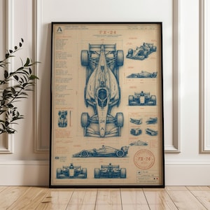 May include: A framed technical blueprint poster of the FX-24 race car on a tan background. The print features detailed blue line drawings of the vehicle from top, side, and front views, accompanied by technical specifications and text labels.