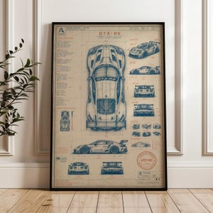 May include: A framed technical blueprint poster of a GT3-RS sports car. The print features detailed blue line drawings of the vehicle from top, side, front, and rear perspectives, accompanied by technical specifications, measurements, and text.