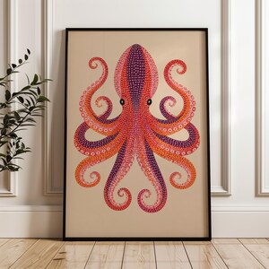 May include: A framed wall art print featuring a stylized octopus illustration on a beige background. The octopus is rendered in vibrant shades of purple, orange, and red, decorated with a detailed pattern of small white dots across its body.
