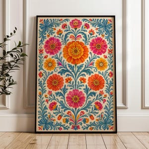 May include: A rectangular framed wall art print featuring a symmetrical floral pattern on a cream background. The design includes large orange and pink flowers surrounded by intricate blue leafy vines and smaller orange and pink blossoms.
