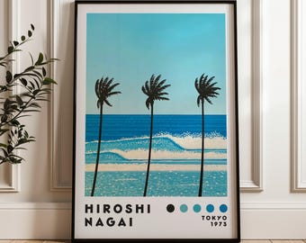 May include: A black framed poster with a blue and white beach scene featuring three palm trees and waves. The poster has the text "HIROSHI NAGAI" and "TOKYO 1973" at the bottom.