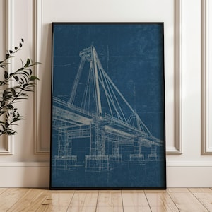 May include: A framed wall art print featuring a detailed architectural blueprint of a cable-stayed bridge. The design is rendered in white lines against a deep navy blue background, showcasing the structural engineering of the bridge towers.