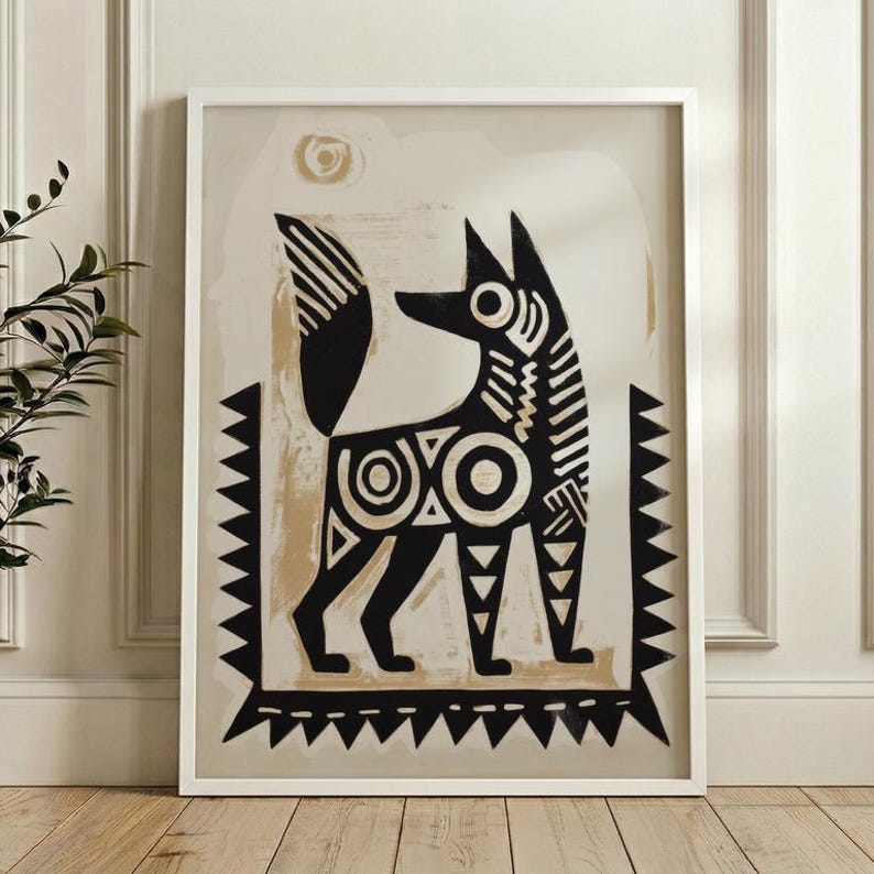 A young girl and an older woman are sitting together, with the girl holding up a framed artwork featuring a stylized dog design.