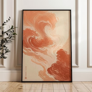 May include: A rectangular framed wall art print featuring an abstract fluid design in shades of terracotta, burnt orange, and cream. The artwork displays swirling, wave-like patterns and includes small vertical Chinese characters in the bottom left.