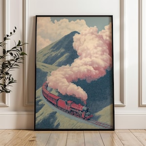 May include: Framed art print depicting a vintage train journey through a mountainous region. The red train emits pinkish-white smoke against a backdrop of green hills, a blue sky, and white clouds. The artwork evokes a sense of travel and nostalgia.