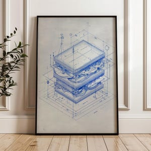 May include: A framed blueprint-style print of a layered sandwich, rendered in blue lines on a neutral background. The artwork showcases an exploded view, highlighting the sandwich's components and construction. The print is encased in a black frame.