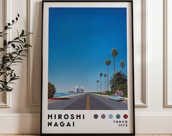 May include: A framed print of a retro-style illustration of a road with palm trees and a car driving down it. The sky is blue and the road is gray. The print is by Hiroshi Nagai and is from 1973.