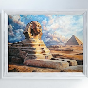 Puede incluir: Obra de arte enmarcada que representa la Gran Esfinge de Giza y una pirámide bajo un cielo nublado. La Esfinge es una estatua grande y antigua con cuerpo de león y cabeza humana. La obra está en un marco blanco.