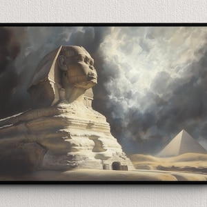May include: A framed print showing the Great Sphinx and a pyramid set against a dramatic, cloudy sky. The artwork uses a muted palette of beige, tan, and grey, creating a sense of ancient history and mystery. The Sphinx is the central element.