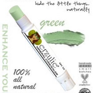 May include: Green mineral concealer stick with the text "Derzulie Mineral Concealer" and "100% all natural" printed on the label. The product is labelled "green" and has an SPF of 20.